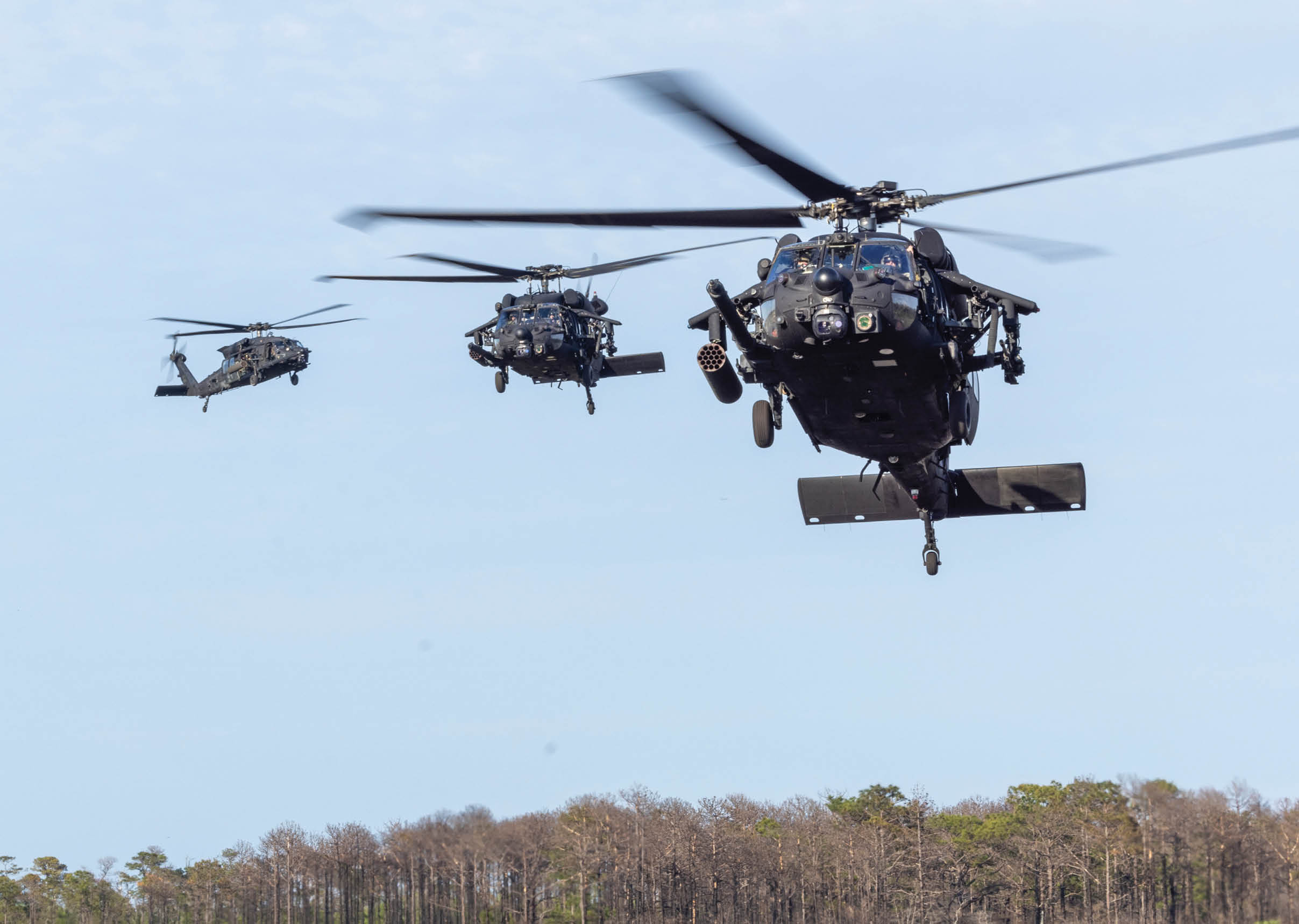 Three helicopters flying in formation over a field. AI generated content