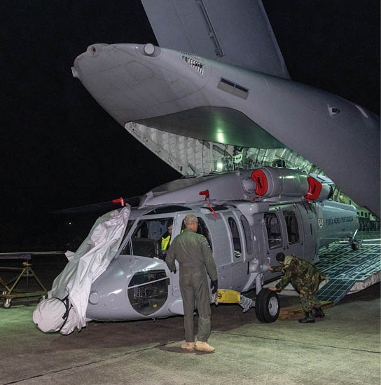 A man is standing next to a helicopter with its door open. AI generated content