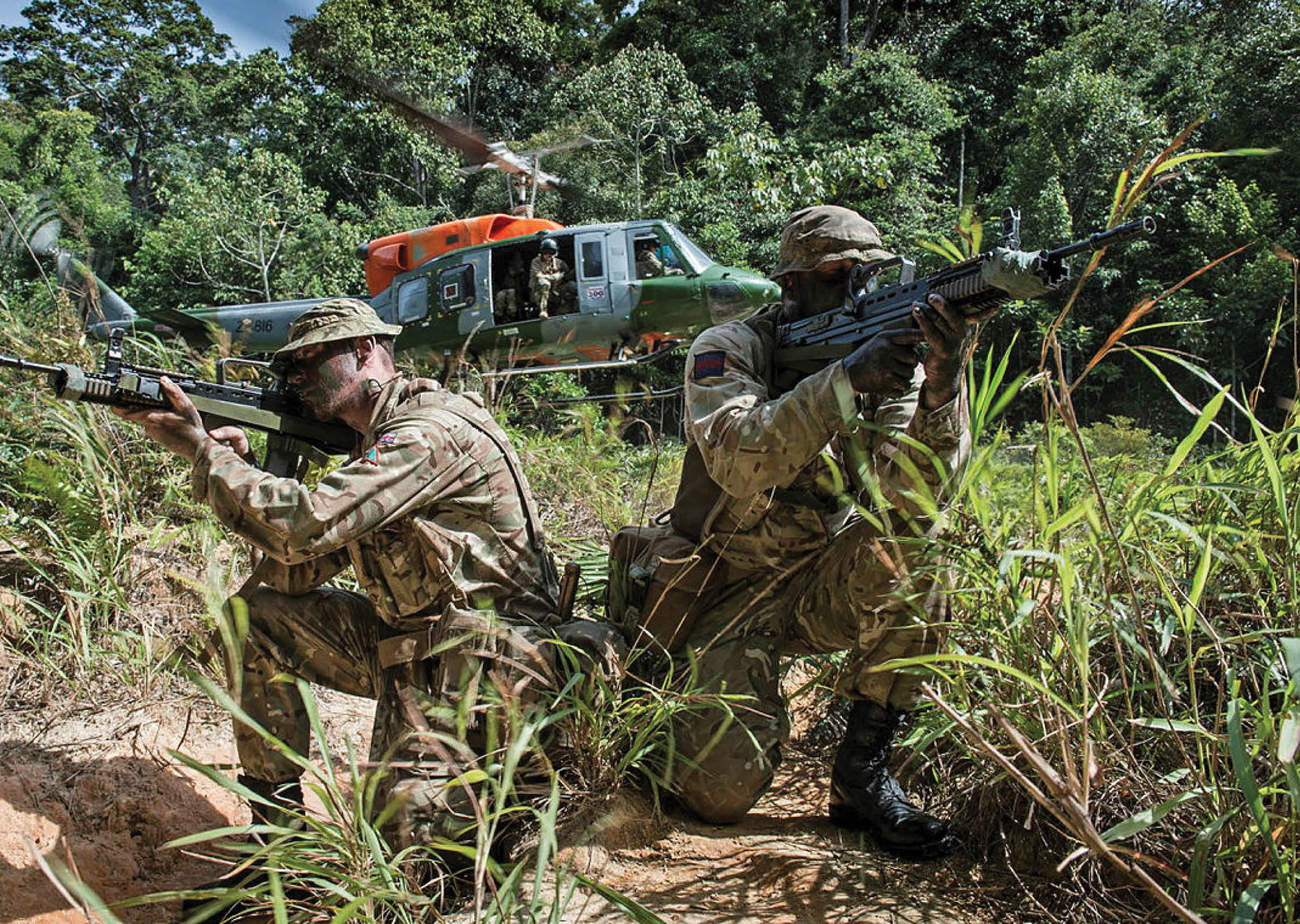 Two men in military uniforms are holding guns and aiming them at a helicopter. AI generated content