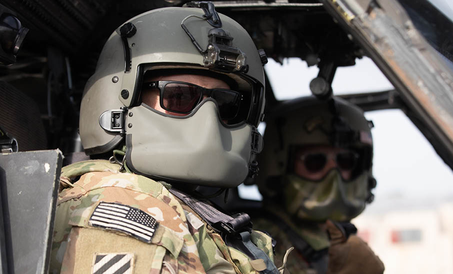 Two soldiers wearing helmets and sunglasses are in a helicopter. AI generated content