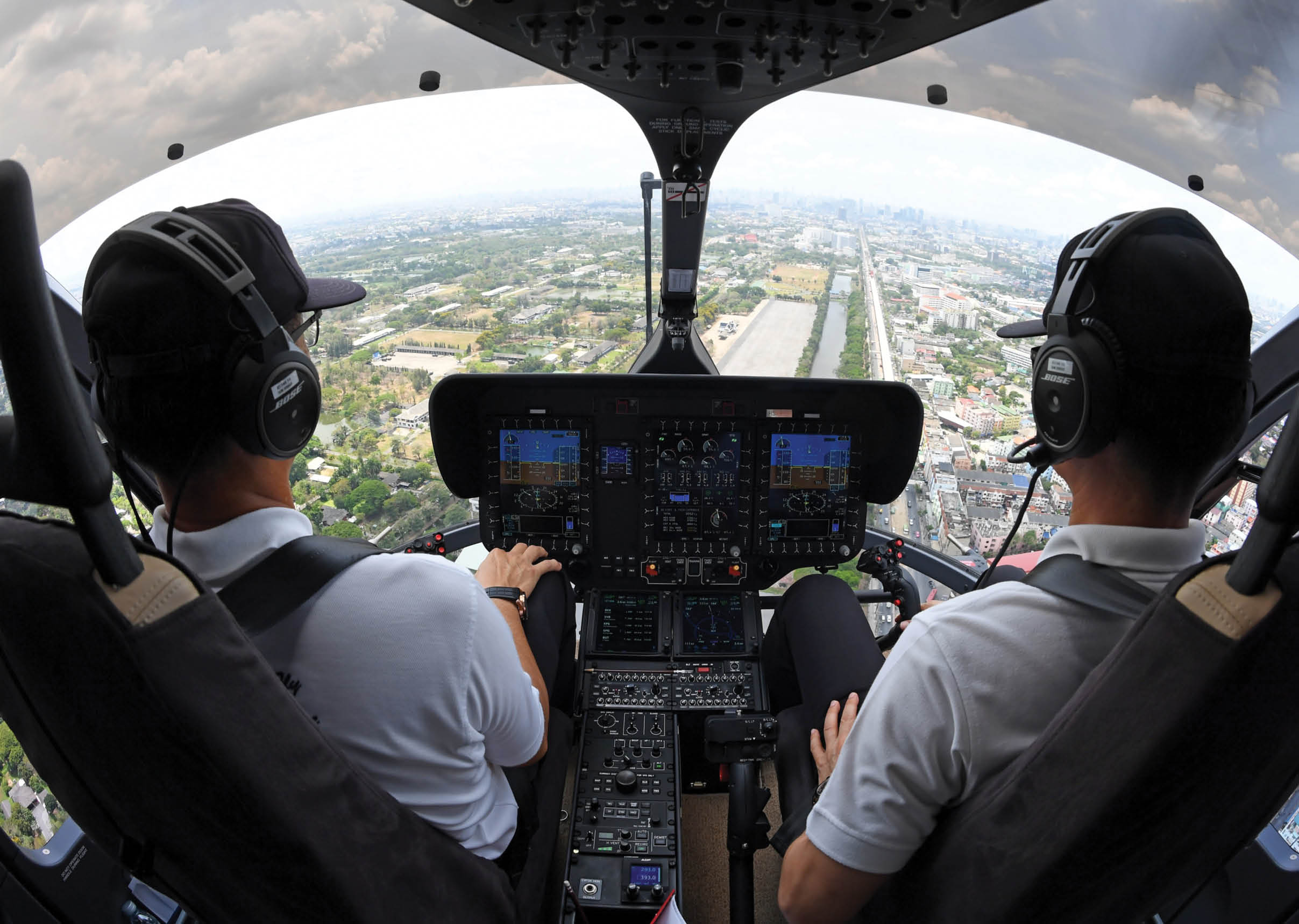Two men are sitting in a helicopter, wearing headphones and enjoying the view. AI generated content