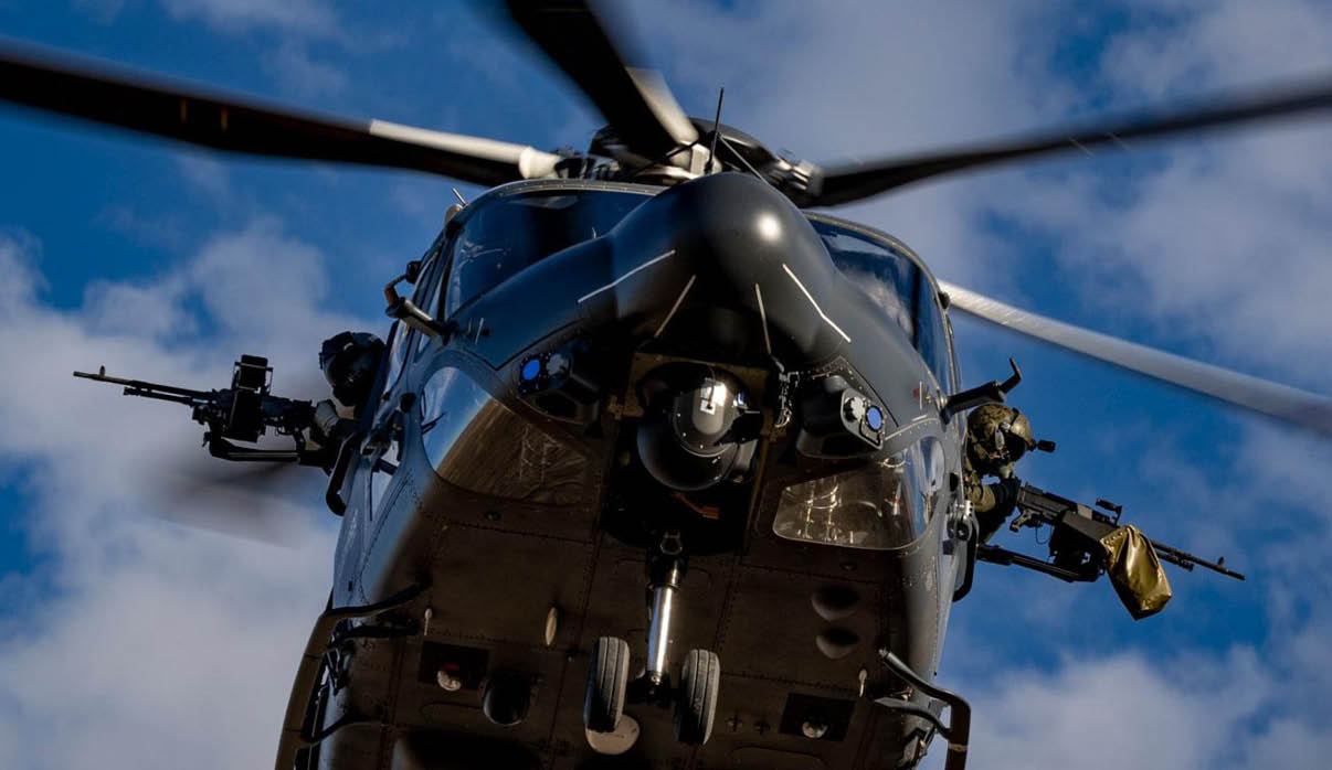 A helicopter with a gun mounted on it flies through the sky. AI generated content
