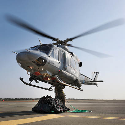 A helicopter is hovering above a man who is holding a rope. AI generated content