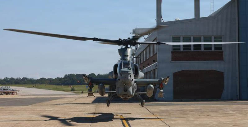 A helicopter is parked on a tarmac in front of a building. AI generated content