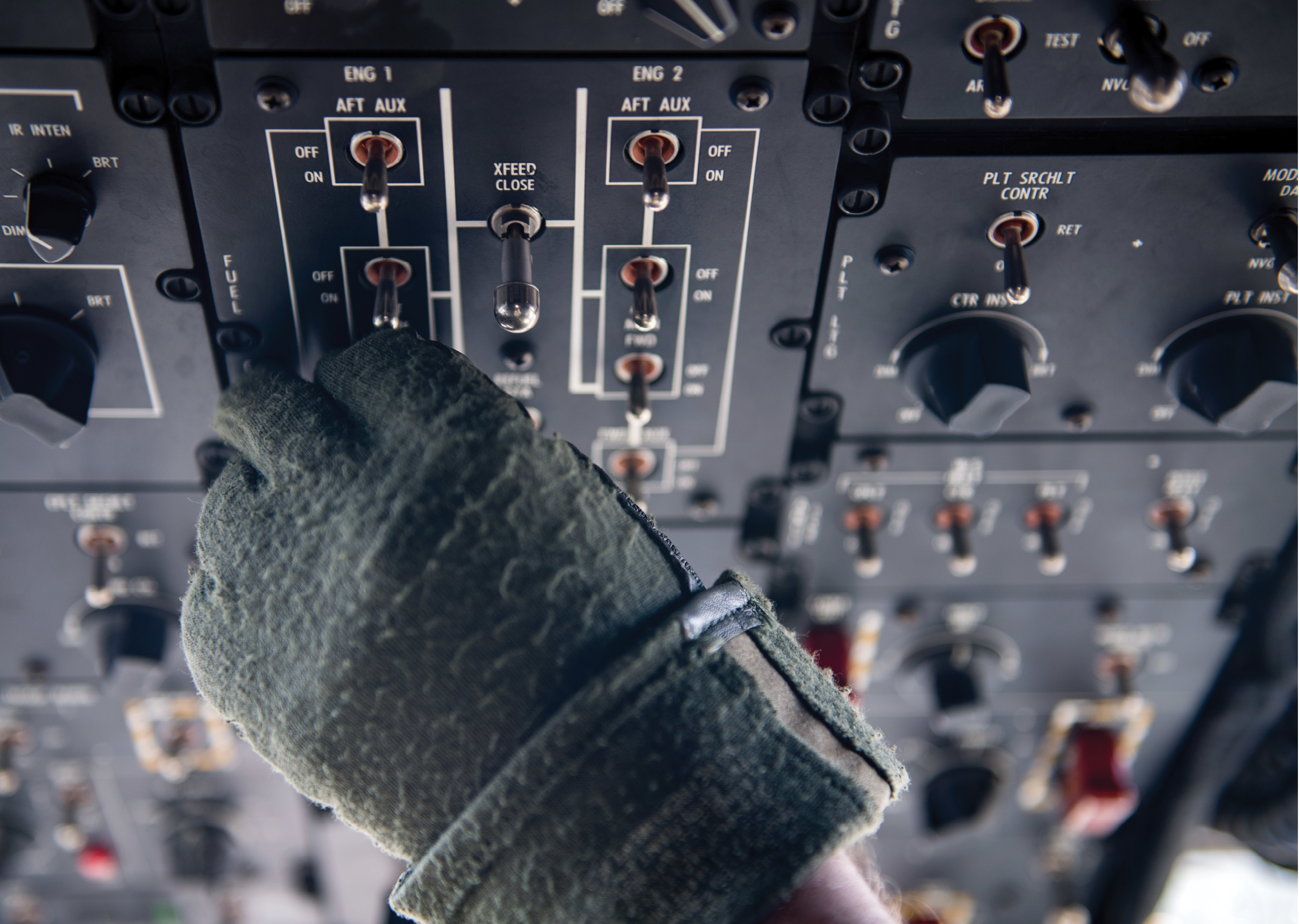 A person wearing gloves is touching a control panel. AI generated content