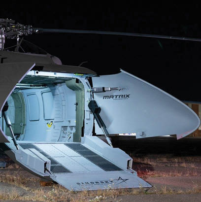 A helicopter with a ladder on the side. Description generated by AI