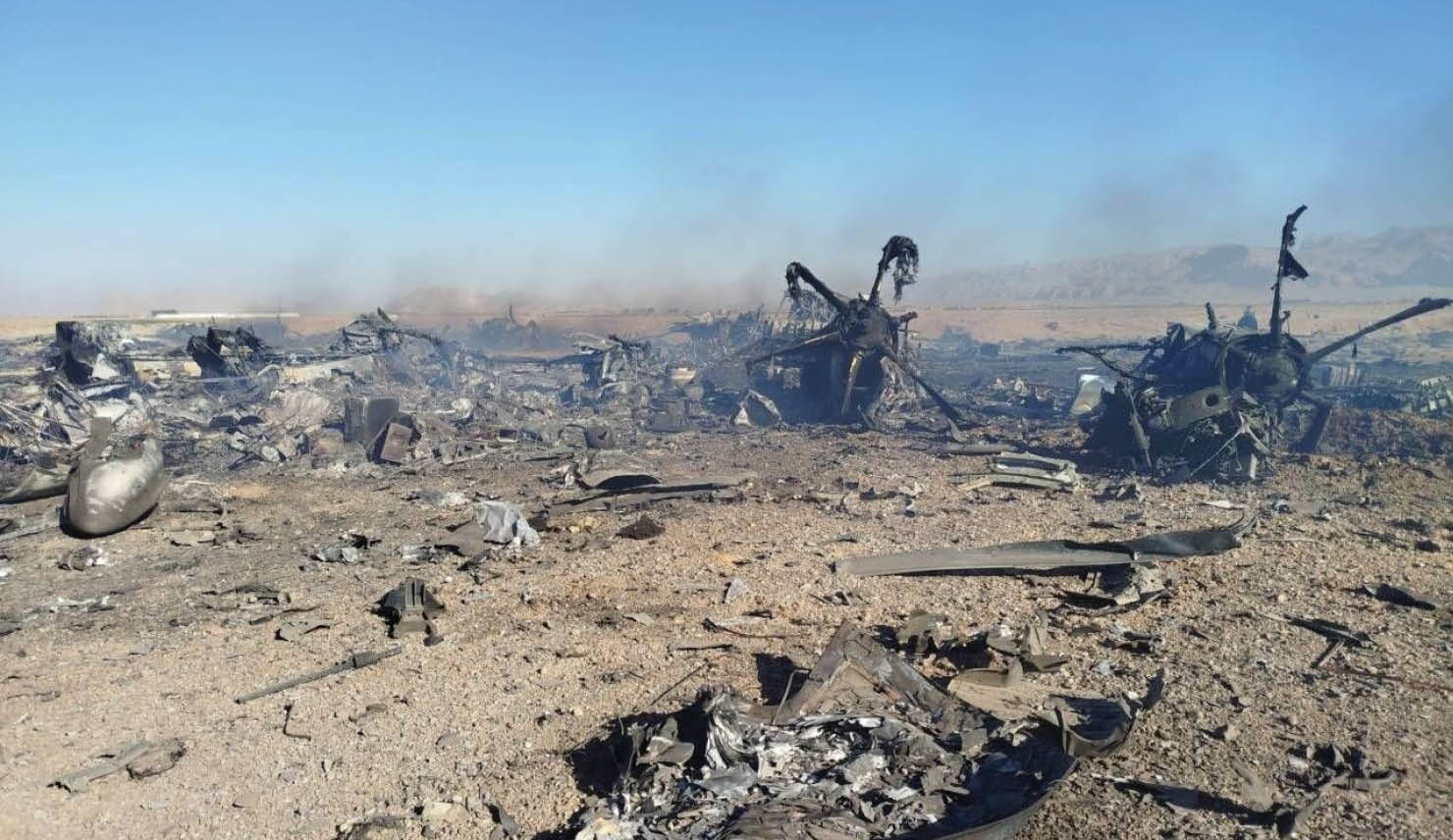 A plane crash site with wreckage on the ground. Description generated by AI