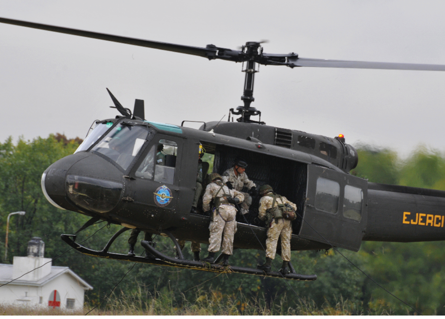 A helicopter with three men in it. Description generated by AI