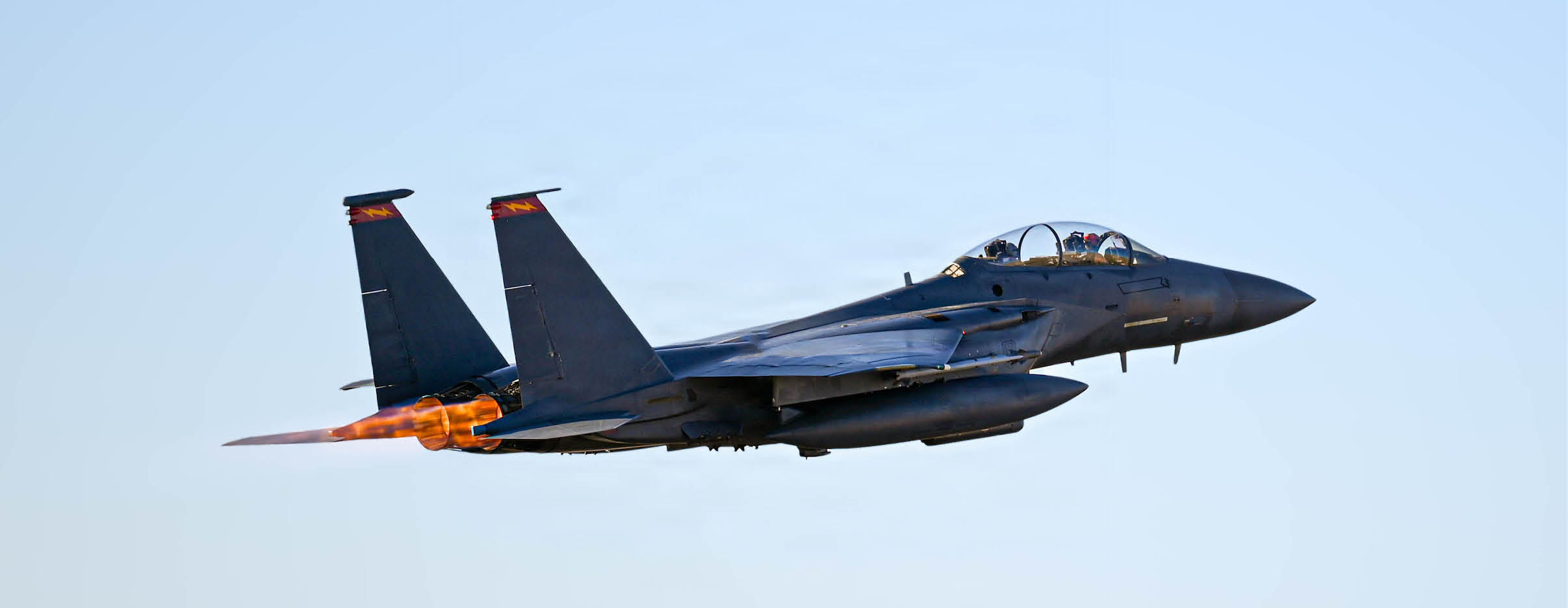 A jet is flying in the sky with a missle on the back. Description generated by AI
