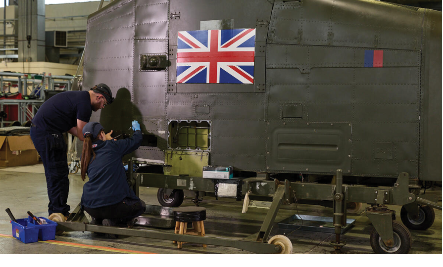 Two men working on a plane. Description generated by AI