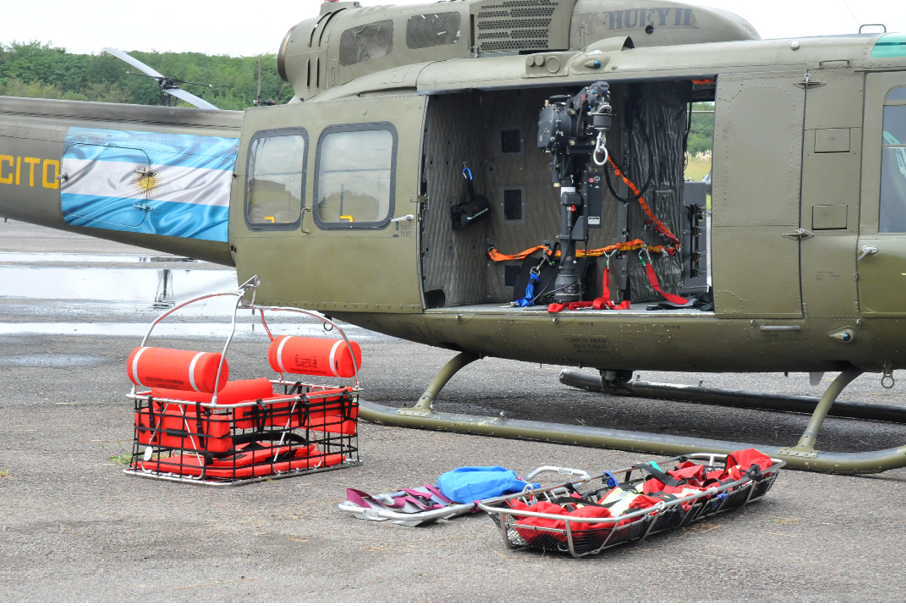 A helicopter with a red and blue bag on the ground. Description generated by AI