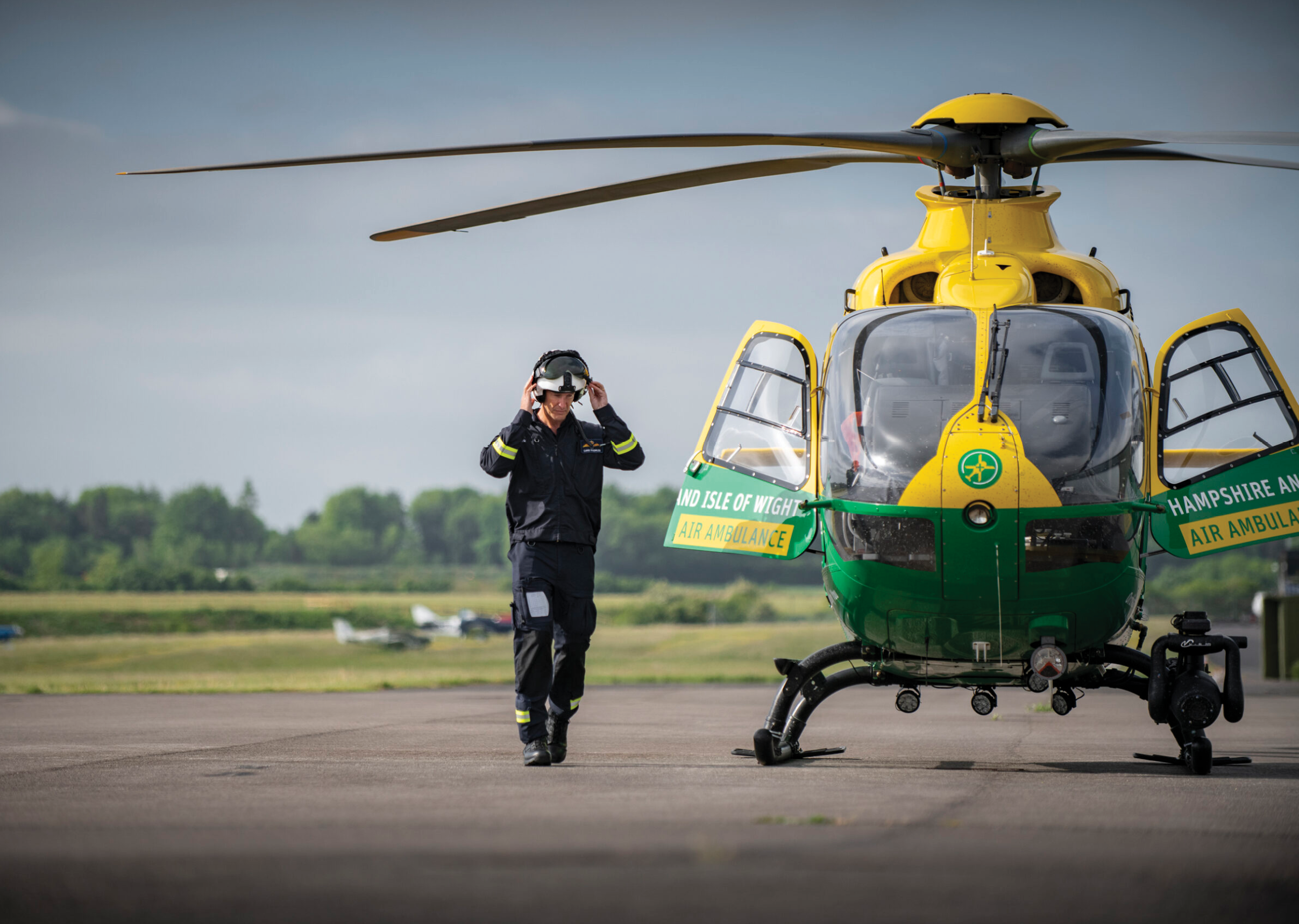 A man in a black and yellow helicopter. Description generated by AI