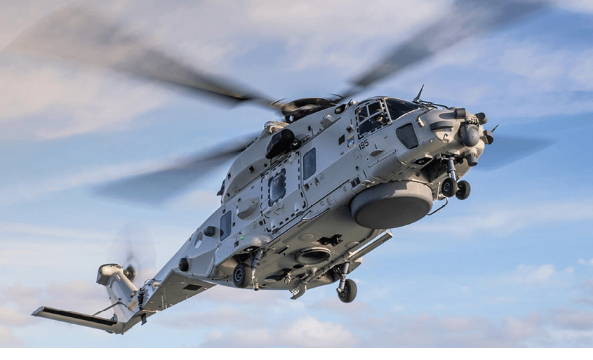 A helicopter flying in the sky. Description generated by AI