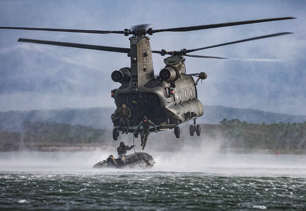 A helicopter is flying over a body of water. Description generated by AI