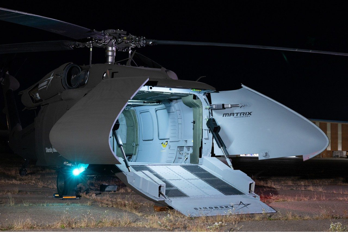 A helicopter with a ladder on the side. Description generated by AI