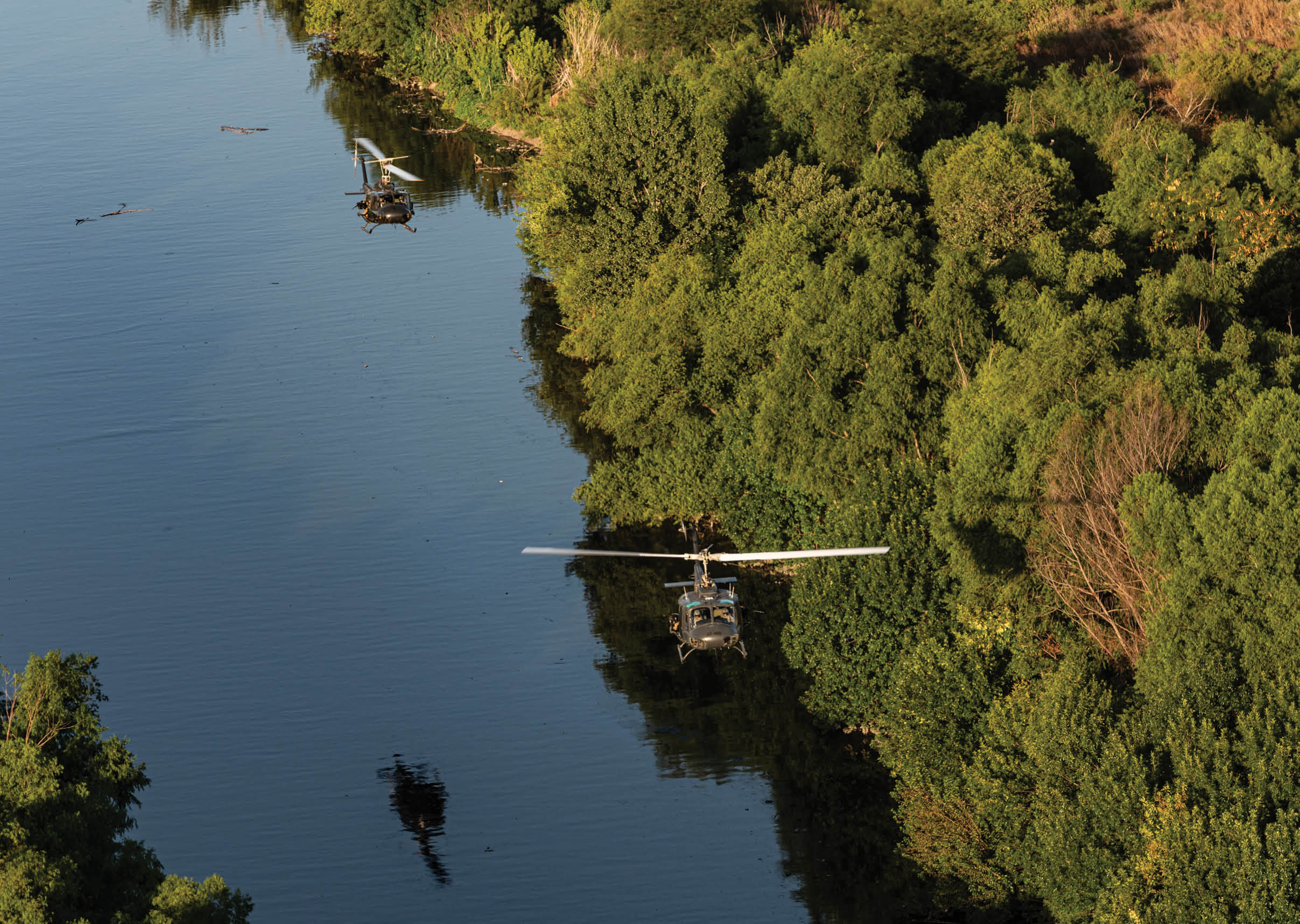 A helicopter is flying over a river. Description generated by AI
