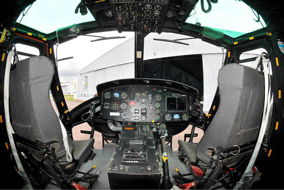 A cockpit of a plane with a lot of controls. Description generated by AI