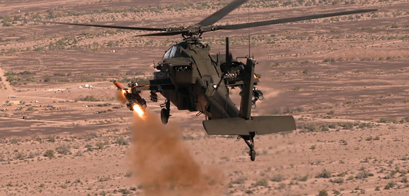 A helicopter is flying in the air and shooting a missile. Description generated by AI