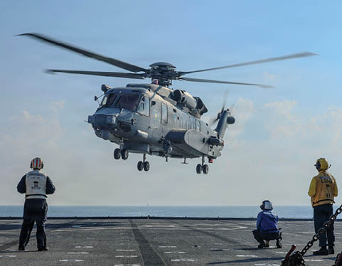 A helicopter is flying above a group of people on a boat. Description generated by AI