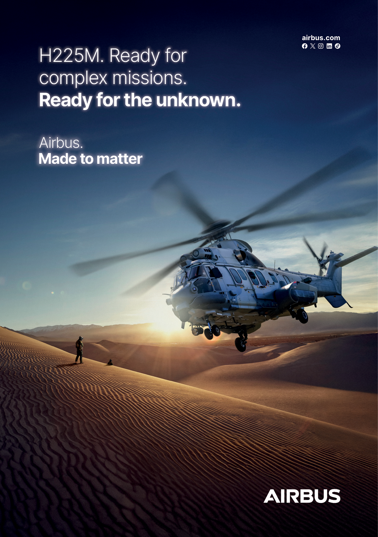An Airbus helicopter is flying over a desert. Description generated by AI