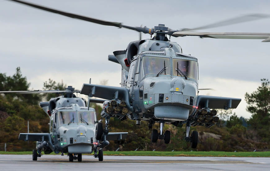 Two helicopters on a runway. Description generated by AI