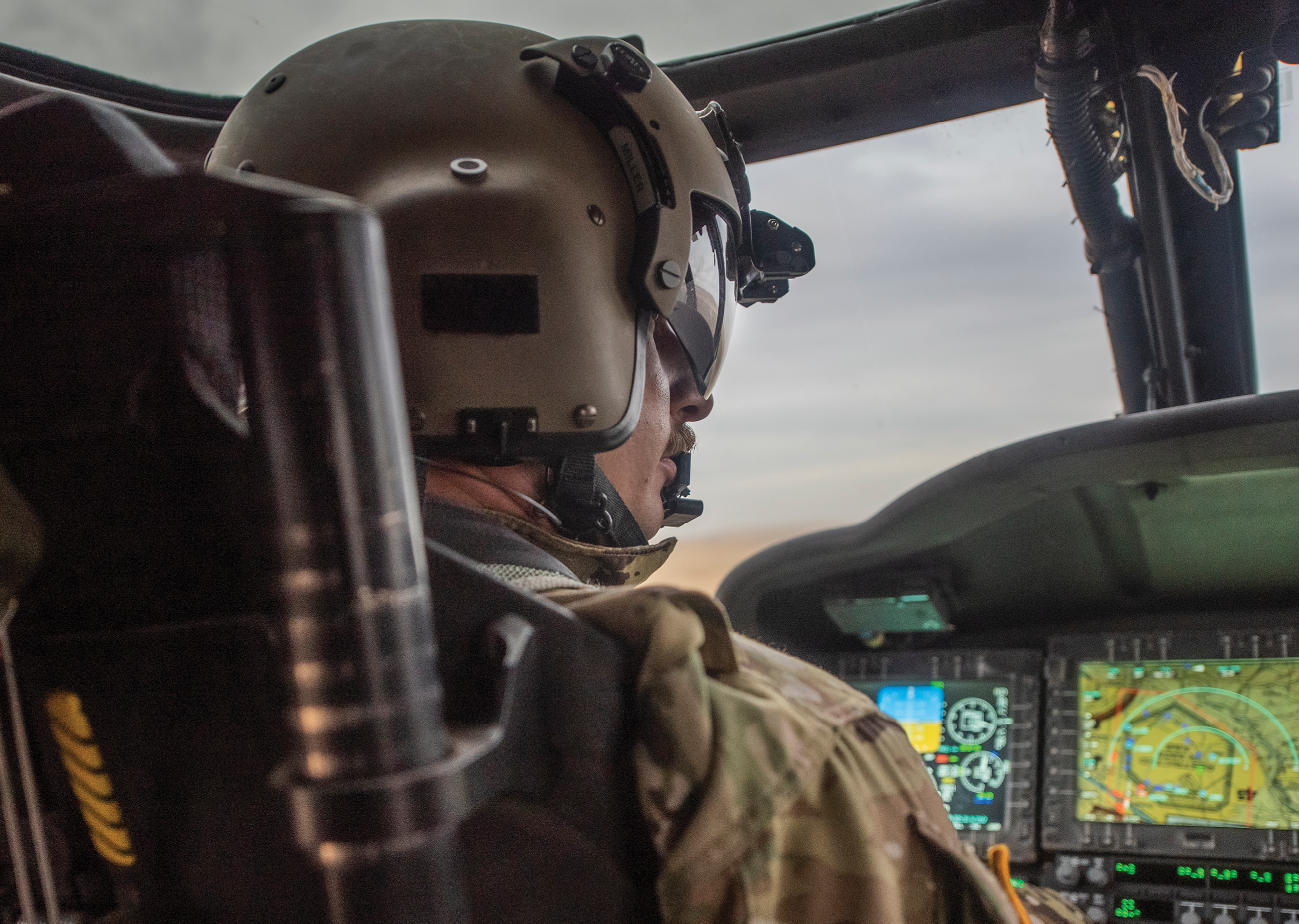 Two men are in a cockpit of a plane. Description generated by AI