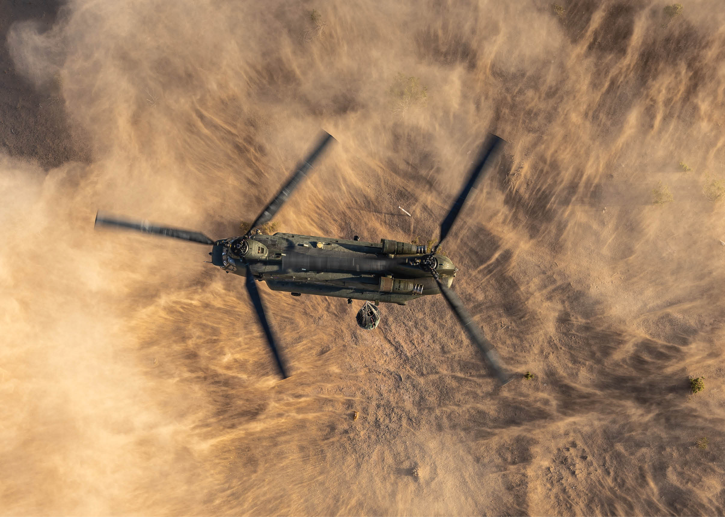 A helicopter flying over a body of water. Description generated by AI