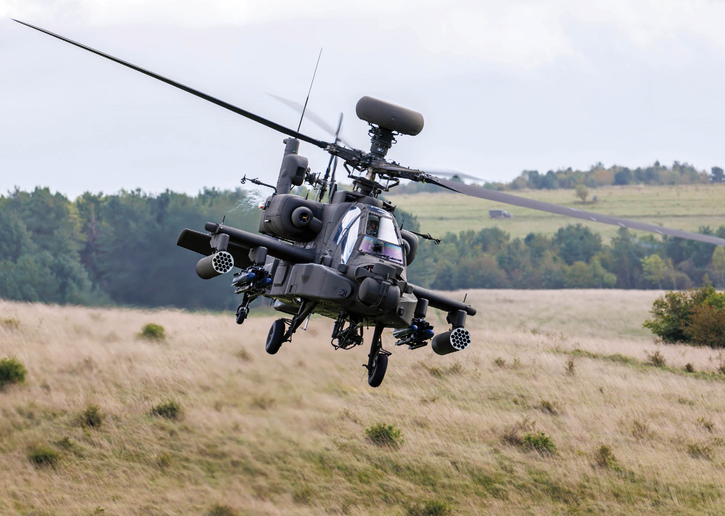 A helicopter with the word “Eureka" on the side is flying over a forest. Description generated by AI