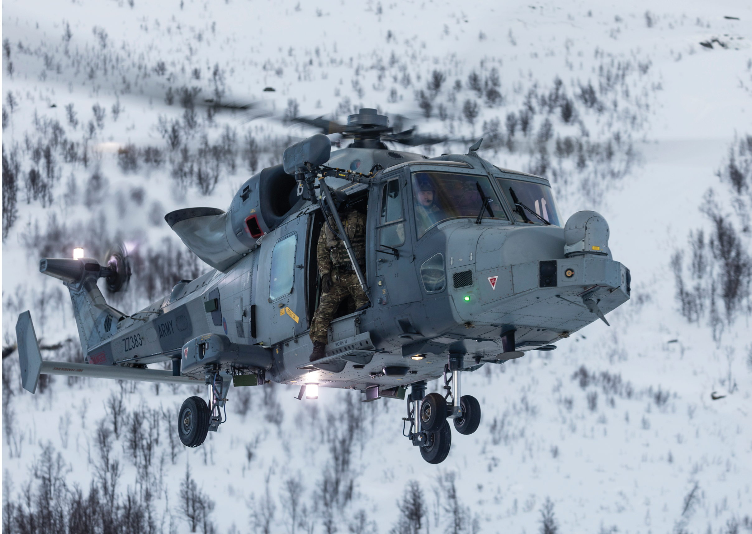 Two helicopters flying in the air. Description generated by AI