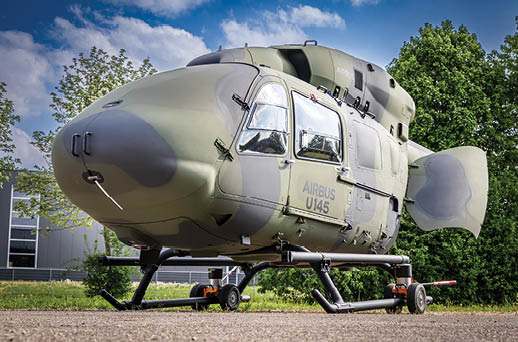 A helicopter is parked in the woods. Description generated by AI