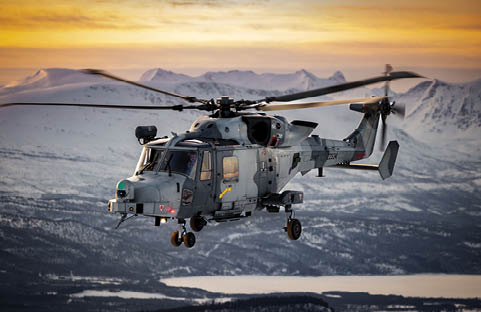 A helicopter is lifting a military vehicle off the ground. Description generated by AI