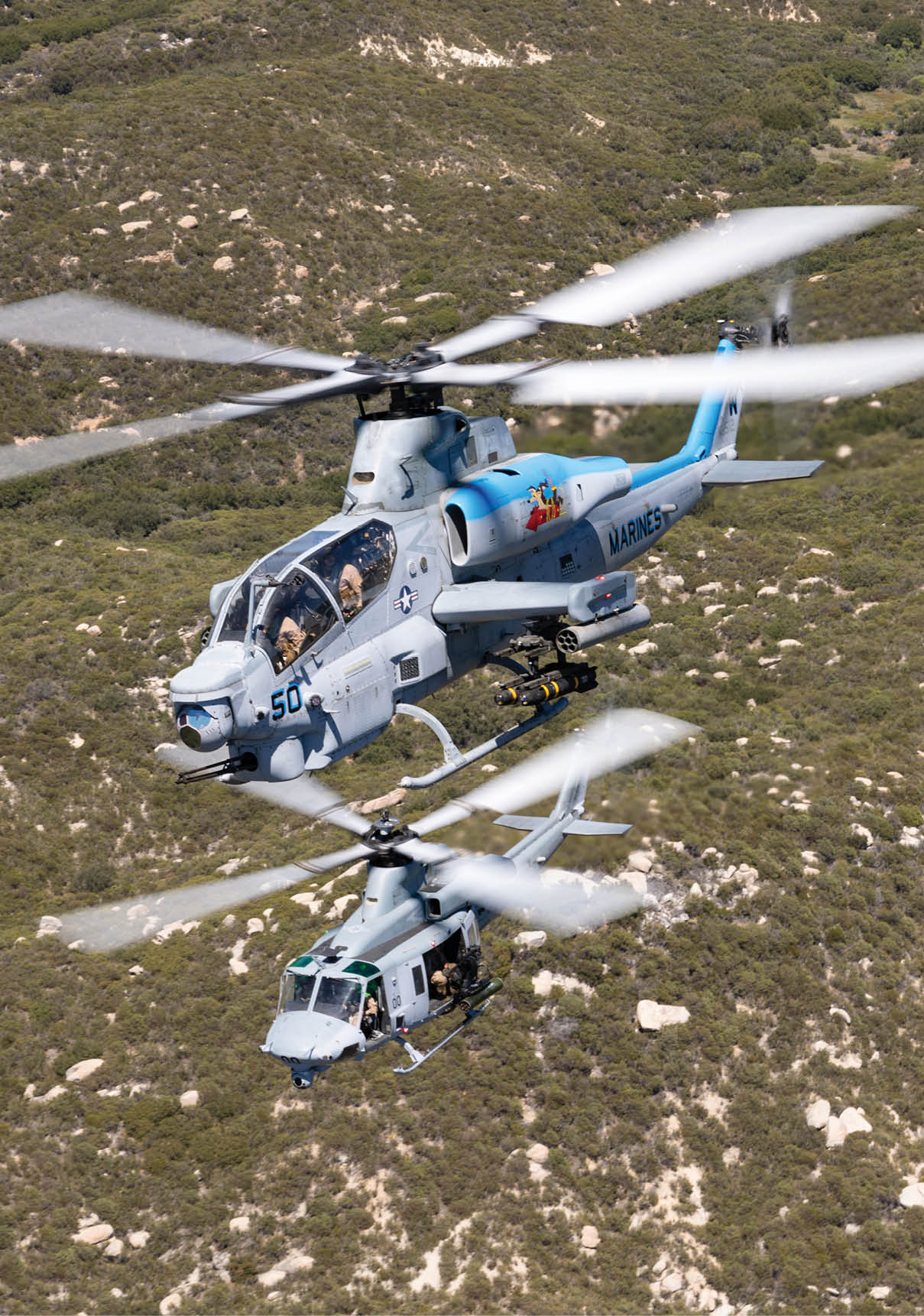 A helicopter is flying over a field of trees. Description generated by AI