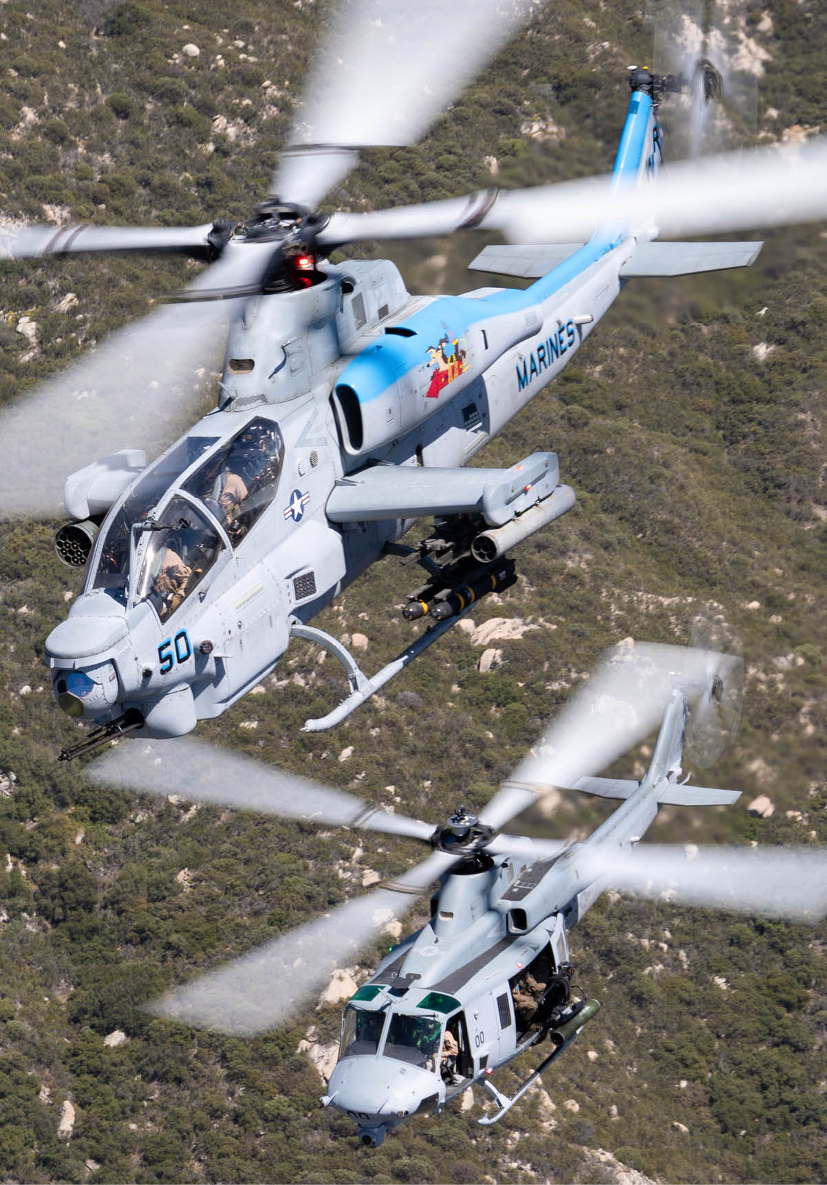 A helicopter with spinning rotor blades flies over a densely vegetated hillside. Description generated by AI