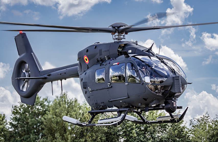 A helicopter with a large propeller is flying over a body of water. Description generated by AI