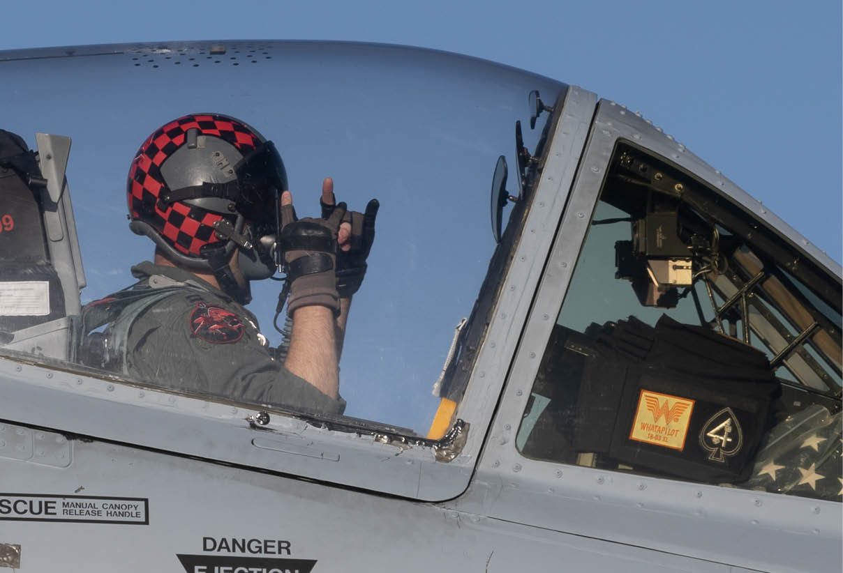 A man is in the cockpit of a fighter jet, wearing a helmet and goggles. AI generated content