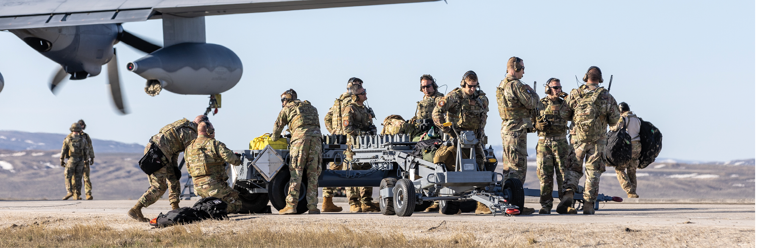 A group of soldiers are unloading equipment from a plane. AI generated content