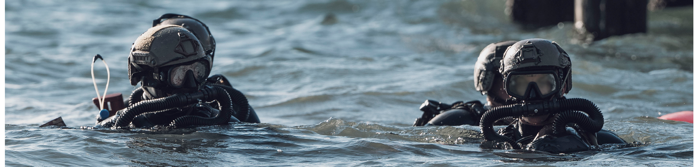 Two men in military uniforms are swimming in the ocean. AI generated content