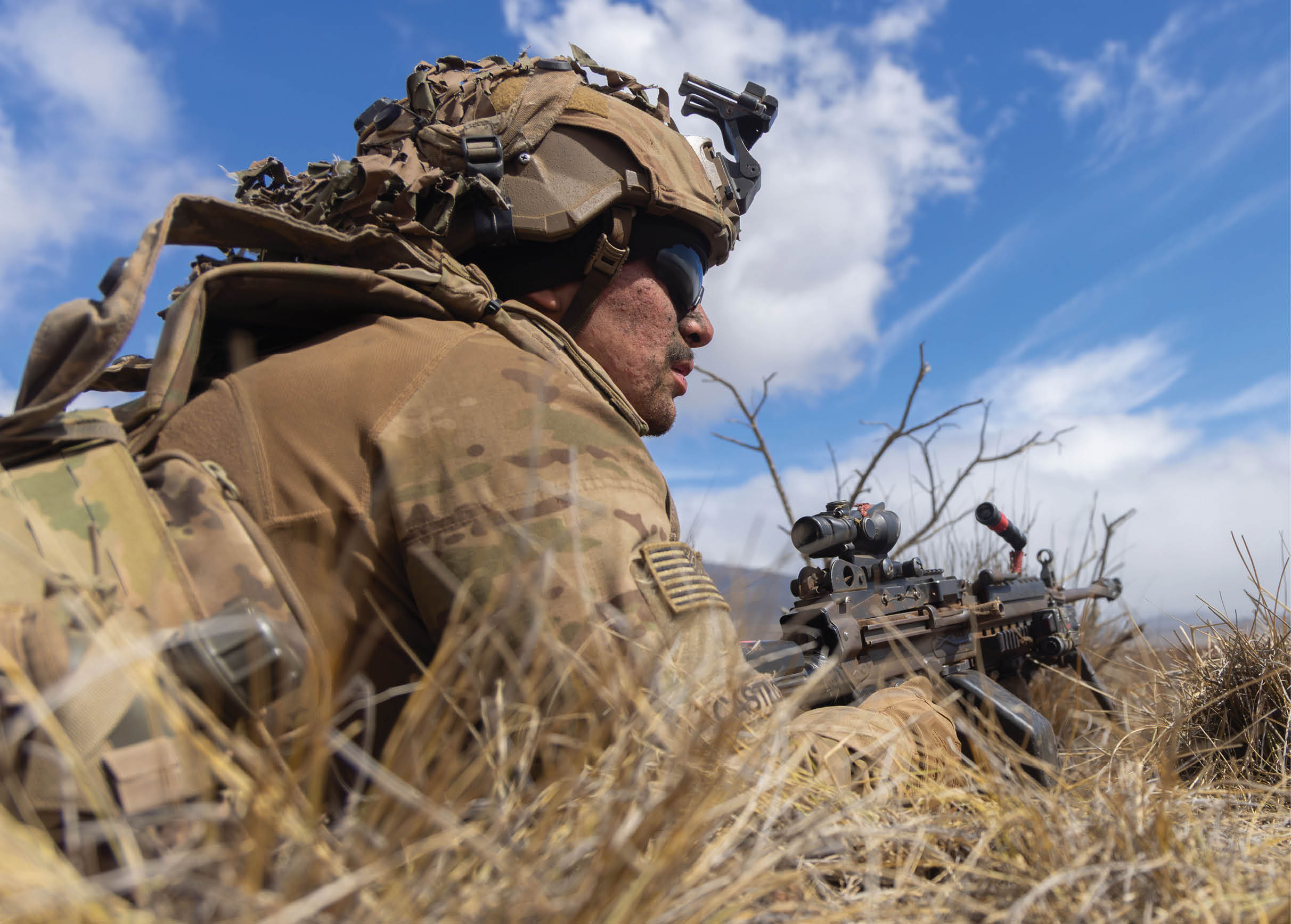 A man in a camouflage uniform is sitting in tall grass, holding a rifle. AI generated content