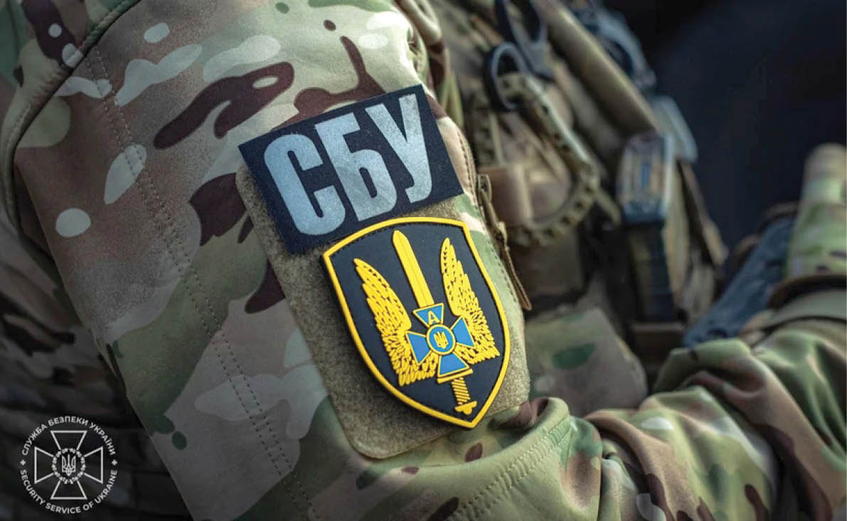 A camouflage patterned shirt with a yellow and blue emblem on it. AI generated content