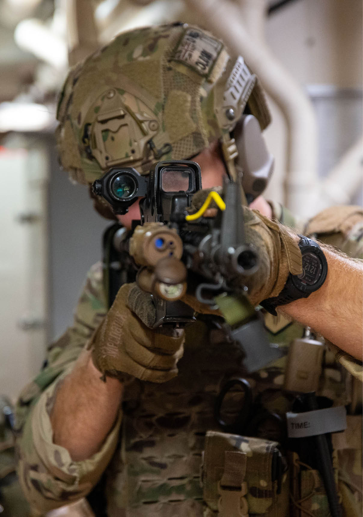 A man in a military uniform is holding a gun and looking through a window. AI generated content