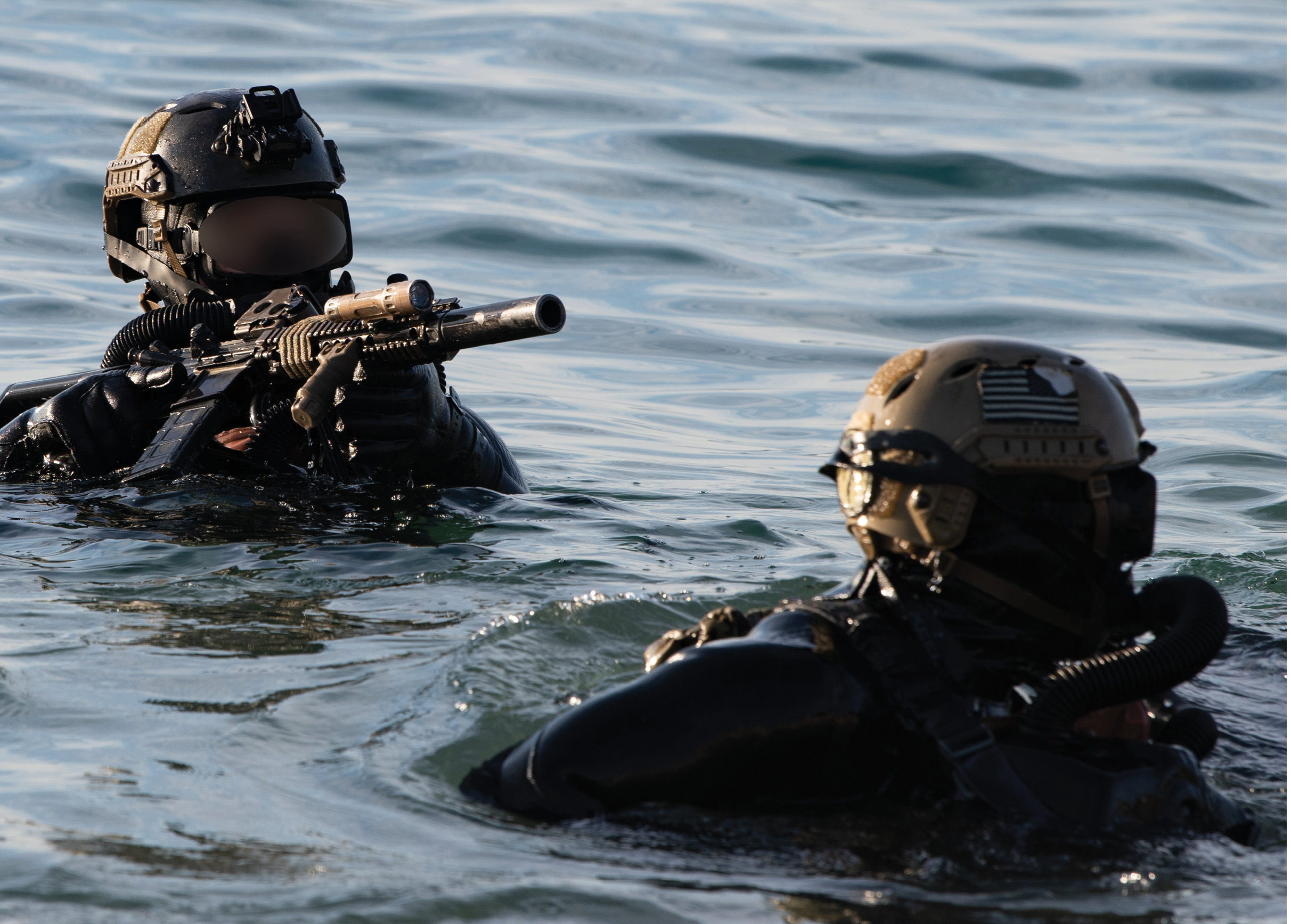 Two men in black wetsuits are in the water, each holding a gun. AI generated content