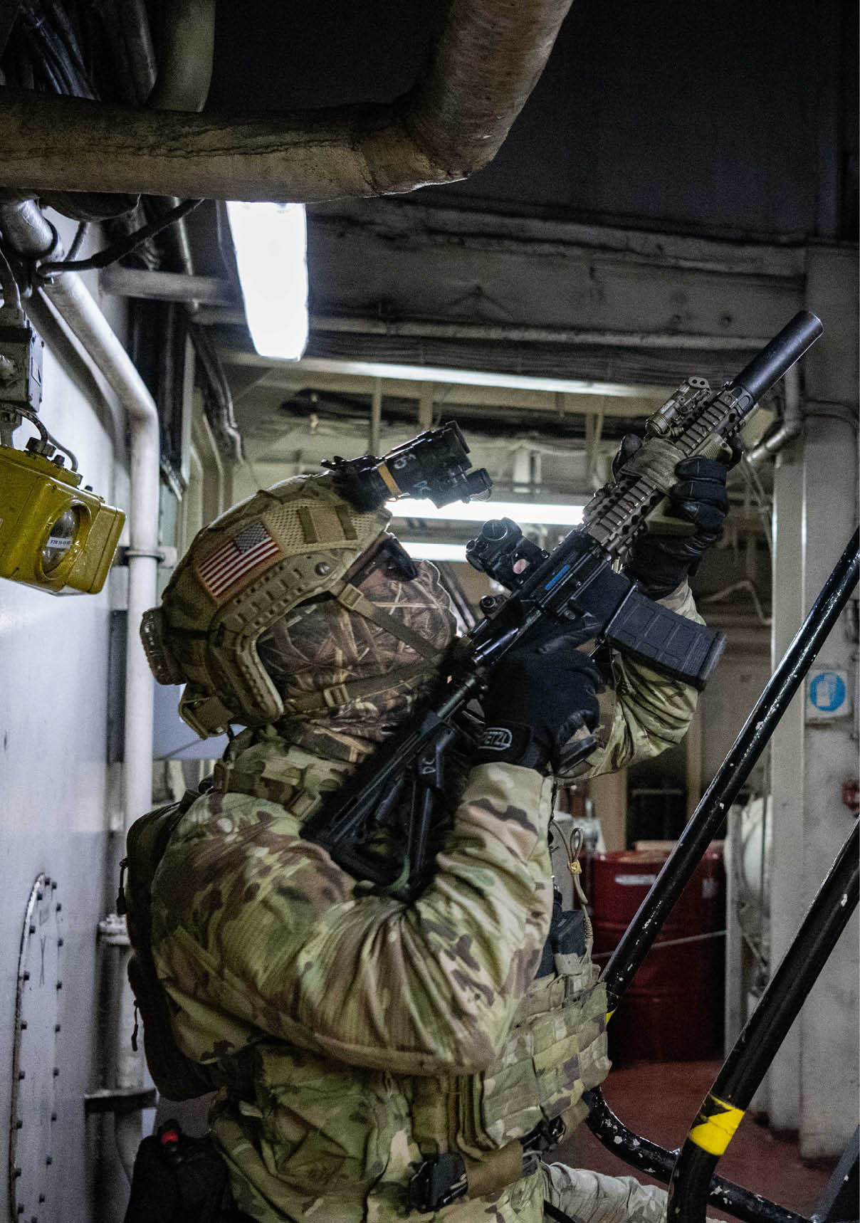 A man in camouflage is holding a gun and looking up the stairs. AI generated content