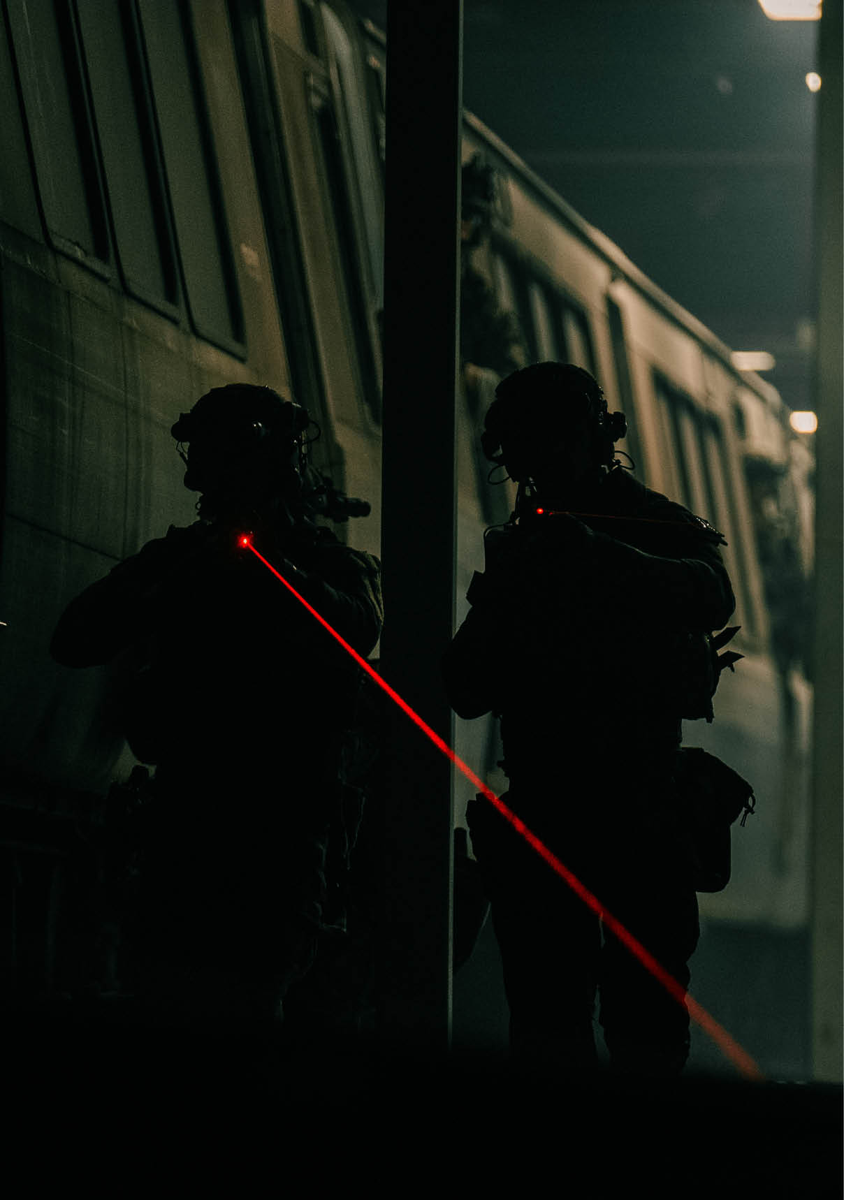 Two men are standing next to a train, one of them is wearing a helmet. AI generated content