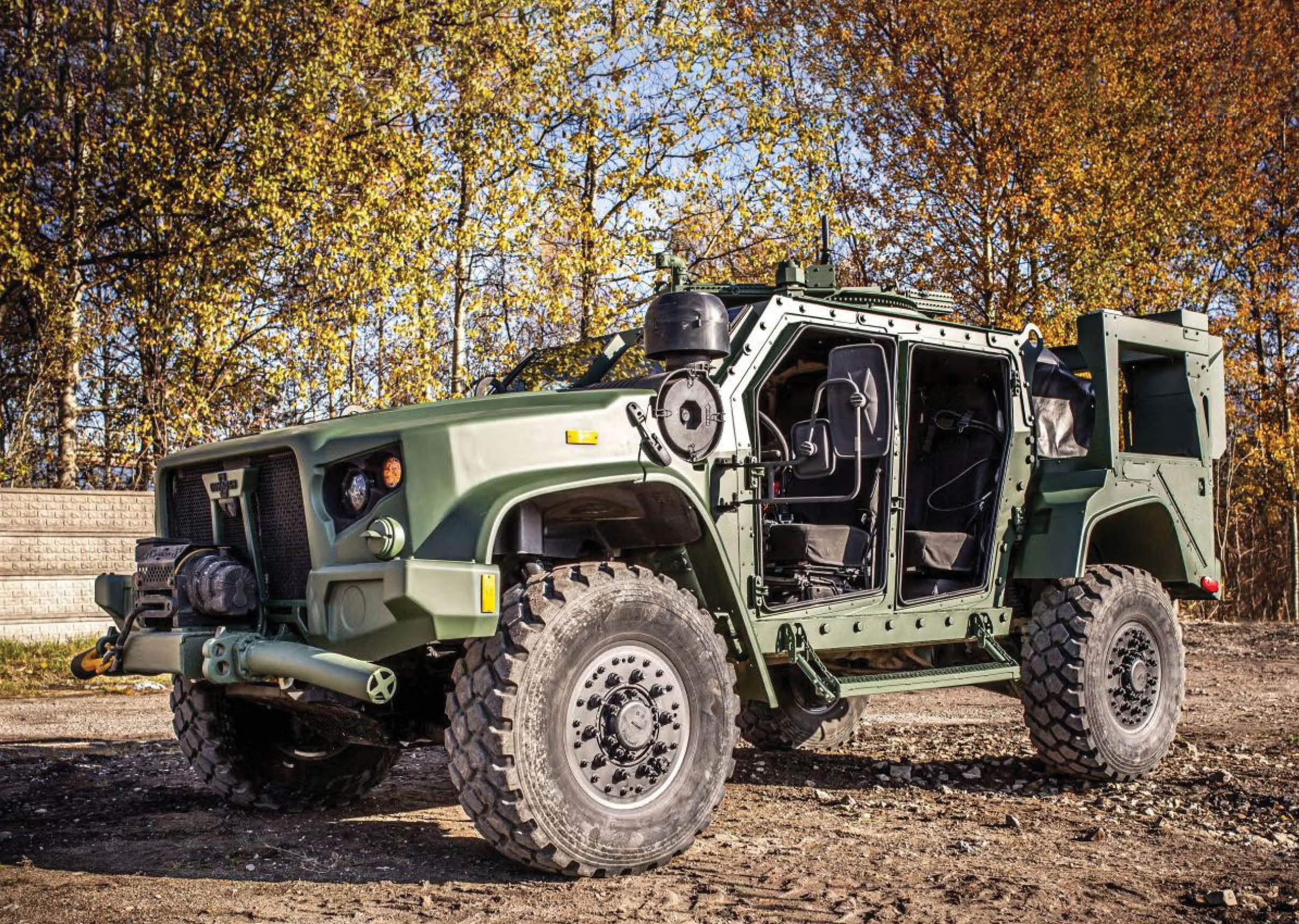 A green military vehicle with a large tire is parked in a dirt lot. AI generated content