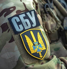 A person wearing a camouflage jacket with a yellow and blue emblem on it. AI generated content