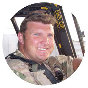 A man wearing a camouflage uniform is sitting in a helicopter, smiling and posing for a picture. AI generated content