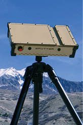 A camera is set up on a tripod in front of a mountain. Description generated by AI