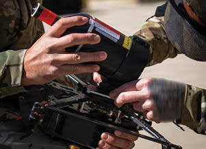 A person is fixing a drone. Description generated by AI