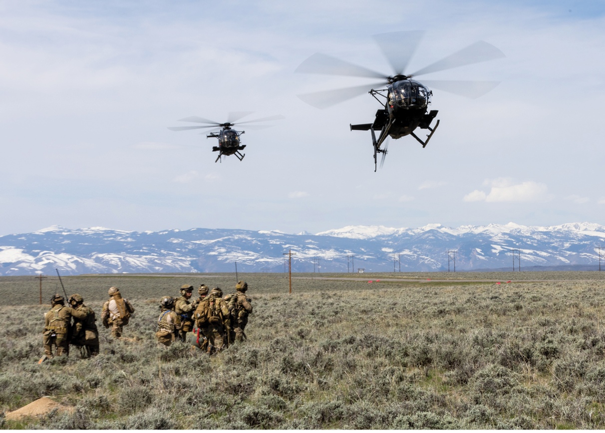 Two helicopters flying over a field with soldiers. Description generated by AI