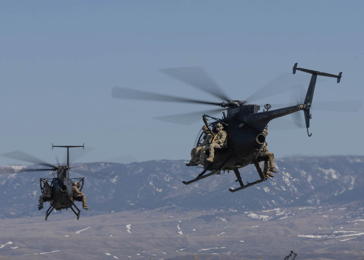 Two helicopters flying in the sky. Description generated by AI